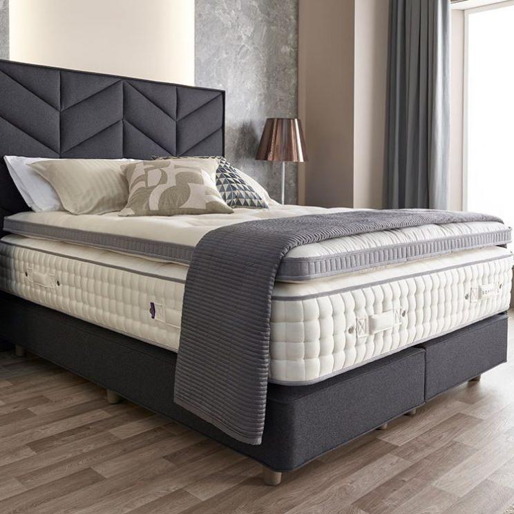 Harrison Spinks Luxury Enhancer mattress topper on a styled bed.